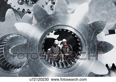 Engineers with cogs and gears View Large Photo Image Stock Image - Engineers with cogs and gears. Fotosearch