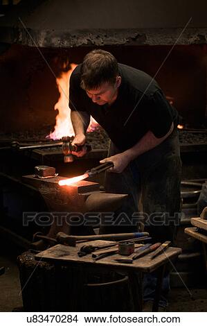 Farrier forging horseshoe on anvil View Large Photo Image Picture - Farrier forging horseshoe on anvil. Fotosearch
