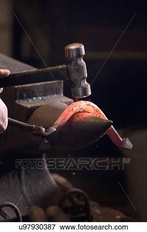Farrier forging horseshoe on anvil View Large Photo Image Stock Photo - Farrier forging horseshoe on anvil. Fotosearch