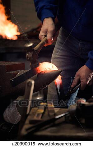 Stock Photography - Farrier forging horseshoe on anvil. Fotosearch