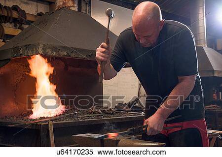Stock Photography - Farrier forging horseshoe on anvil. Fotosearch