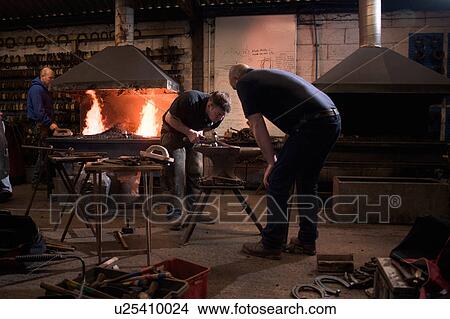 Picture - Farriers forging horseshoe on anvil. Fotosearch
