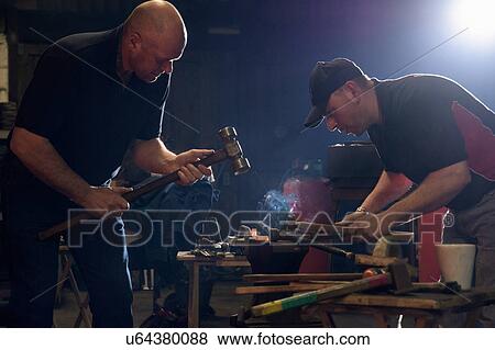 Farriers forging horseshoe on anvil View Large Photo Image Stock Photo - Farriers forging horseshoe on anvil. Fotosearch