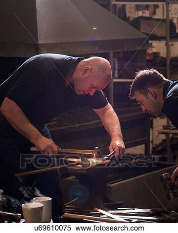 Stock Photography - Farriers forging horseshoe on anvil. Fotosearch