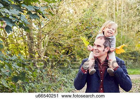 Father carrying daughter on shoulders View Large Photo Image Stock Image - Father carrying daughter on shoulders. Fotosearch
