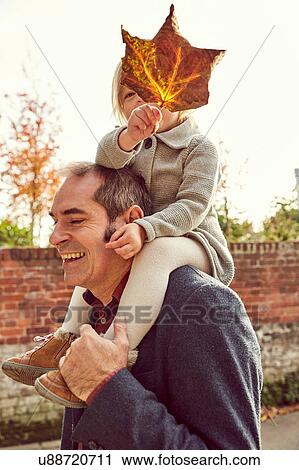 Father carrying daughter on shoulders View Large Photo Image Stock Image - Father carrying daughter on shoulders. Fotosearch