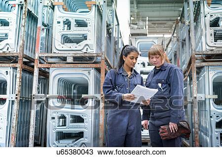 Female apprentice electrician and welder in car factory View Large Photo Image Stock Image - Female apprentice electrician and welder in car factory. Fotosearch