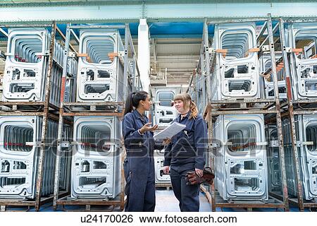 Female apprentice electrician and welder in car factory View Large Photo Image Stock Photograph - Female apprentice electrician and welder in car factory. Fotosearch