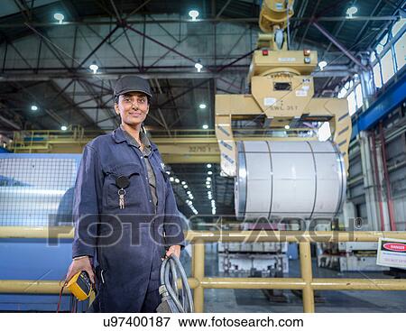 Female apprentice electrician in car factory, portrait View Large Photo Image Stock Photo - Female apprentice electrician in car factory, portrait. Fotosearch