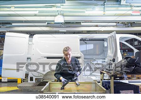 Female apprentice engineer on production line in car factory View Large Photo Image Stock Image - Female apprentice engineer on production line in car factory. Fotosearch