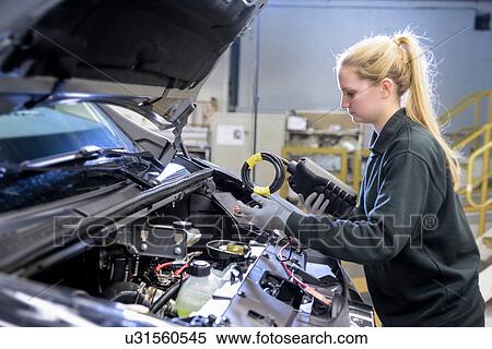 Female apprentice engineer testing car on production line in car factory View Large Photo Image Stock Photography - Female apprentice engineer testing car on production line in car factory. Fotosearch