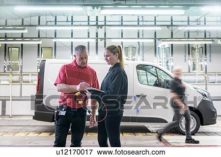 Female apprentice engineer with mentor on production line in car factory View Large Photo Image Stock Photo - Female apprentice engineer with mentor on production line in car factory. Fotosearch