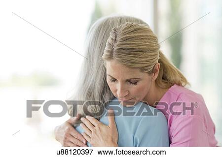 Stock Photo - Female care worker embracing female patient. Fotosearch