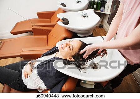 Female customer having hair washed in salon sink View Large Photo Image Stock Photo - Female customer having hair washed in salon sink. Fotosearch