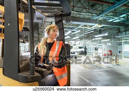 Female forklift driver in car factory View Large Photo Image Picture - Female forklift driver in car factory. Fotosearch