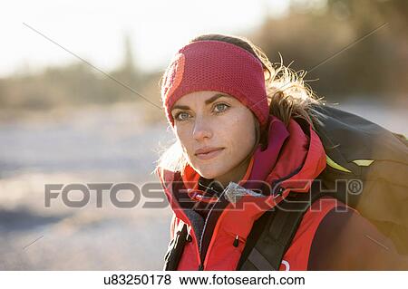 Stock Photo - Female hiker gazing from lakeside in Bavarian Alps. Fotosearch