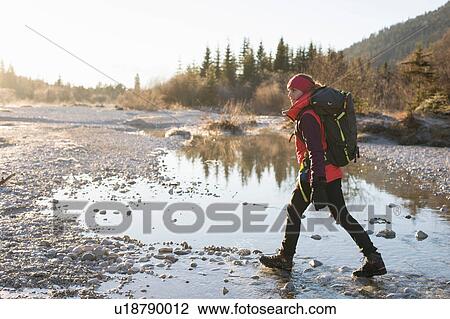 Female hiker hiking along lakeside in Bavarian Alps View Large Photo Image Stock Image - Female hiker hiking along lakeside in Bavarian Alps. Fotosearch