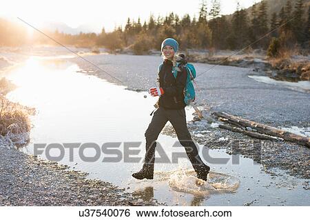Female hiker hiking through water on lakeside in Bavarian Alps View Large Photo Image Stock Photograph - Female hiker hiking through water on lakeside in Bavarian Alps. Fotosearch