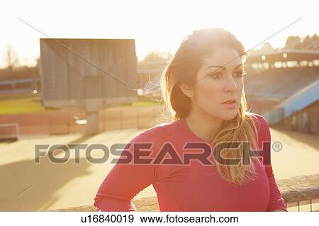 Female runner taking a break in park View Large Photo Image Stock Photo - Female runner taking a break in park. Fotosearch