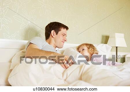 Female toddler and father gazing at each other in bed View Large Photo Image Picture - Female toddler and father gazing at each other in bed. Fotosearch