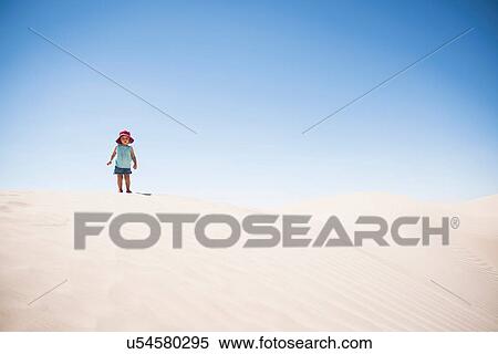 Stock Photography - Female toddler standing on top of sand dune, Little Sahara, Utah, USA. Fotosearch