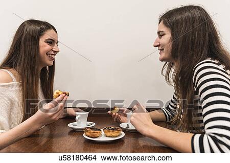 Picture - Friends at table in coffee shop. Fotosearch