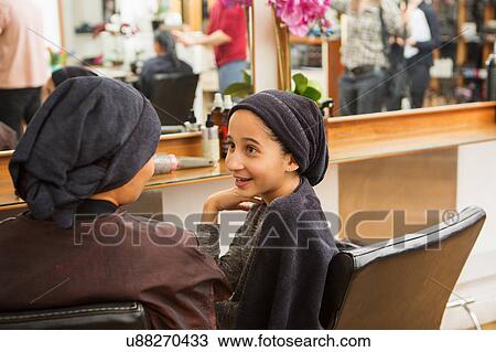 Girl and mother with towels on heads chatting in hair salon View Large Photo Image Stock Image - Girl and mother with towels on heads chatting in hair salon. Fotosearch
