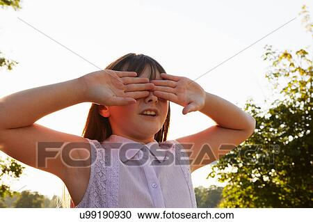 Girl covering eyes for hide and seek in park View Large Photo Image Stock Image - Girl covering eyes for hide and seek in park. Fotosearch