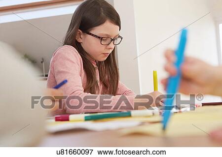 Stock Photo - Girl drawing at table. Fotosearch