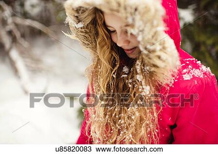 Girl in parka with snow in her hair looking down View Large Photo Image Stock Image - Girl in parka with snow in her hair looking down. Fotosearch