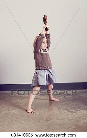 Girl playing holding up old wooden toy guitar View Large Photo Image Stock Photography - Girl playing holding up old wooden toy guitar. Fotosearch