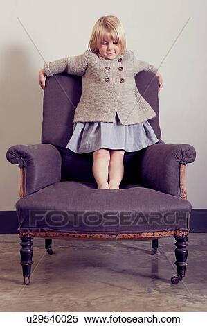 Girl standing on vintage armchair View Large Photo Image Stock Photography - Girl standing on vintage armchair. Fotosearch