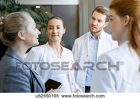 Group of doctors having discussion with consultant View Large Photo Image Stock Photography - Group of doctors having discussion with consultant. Fotosearch