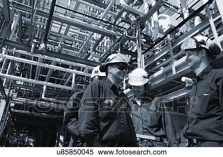 Stock Photography - Group of oil and gas engineers on site. Fotosearch
