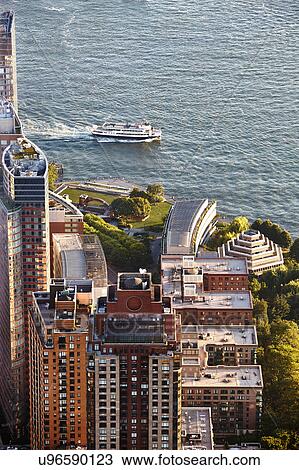 Stock Image - High angle view of ferry and waterfront from One World Trade Observatory, New York City, USA. Fotosearch