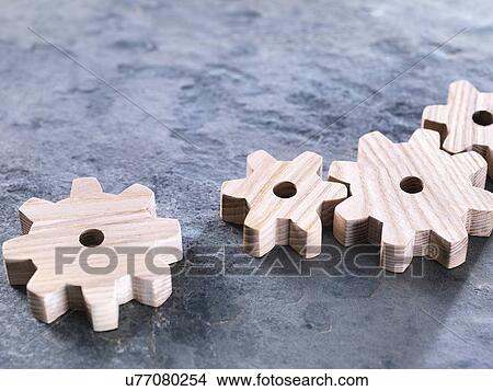 Interlocking wooden cogwheels View Large Photo Image Picture - Interlocking wooden cogwheels. Fotosearch