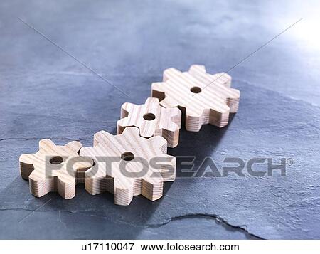 Stock Photo - Interlocking wooden cogwheels. Fotosearch