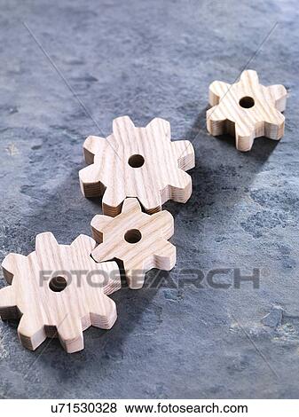 Stock Photo - Interlocking wooden cogwheels. Fotosearch