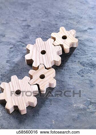 Stock Photograph - Interlocking wooden cogwheels. Fotosearch
