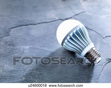 Stock Photo - LED energy efficient light bulb, illuminated. Fotosearch
