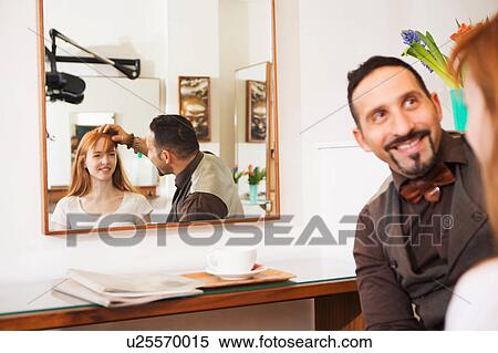 Male hairdresser advising customer on hairstyle in salon View Large Photo Image Stock Photography - Male hairdresser advising customer on hairstyle in salon. Fotosearch