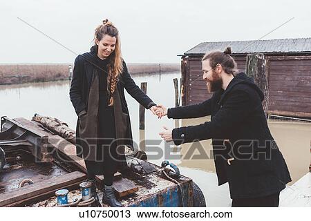 Man helping girlfriend from barge on canal waterfront View Large Photo Image Stock Image - Man helping girlfriend from barge on canal waterfront. Fotosearch