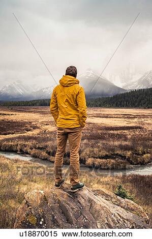 Man standing, looking at view, rear view, Kananaskis Country, Bow Valley Provincial Park, Kananaskis, Alberta, Canada View Large Photo Image Stock Photography - Man standing, looking at view, rear view, Kananaskis Country, Bow Valley Provincial Park, Kananaskis, Alberta, Canada. Fotosearch