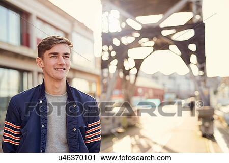 Stock Image - Man walking outdoors, Bristol, UK. Fotosearch