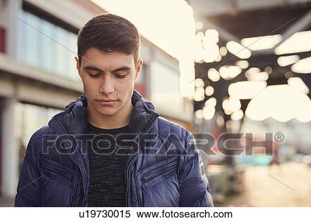 Stock Photography - Man walking outdoors, Bristol, UK. Fotosearch
