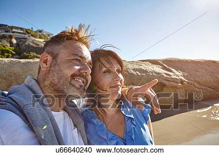 Mature couple on beach, looking at view, Cape Town, South Africa View Large Photo Image Stock Image - Mature couple on beach, looking at view, Cape Town, South Africa. Fotosearch
