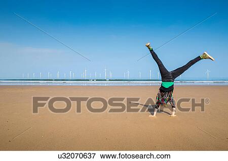 Mature woman doing cartwheel on Redcar beach, North Yorkshire, UK View Large Photo Image Stock Photo - Mature woman doing cartwheel on Redcar beach, North Yorkshire, UK. Fotosearch