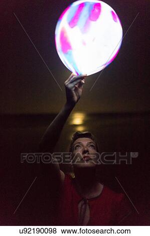 Mature woman holding illuminated balloon on beach at night, Nosara, Guanacaste Province, Costa Rica View Large Photo Image Stock Photo - Mature woman holding illuminated balloon on beach at night, Nosara, Guanacaste Province, Costa Rica. Fotosearch