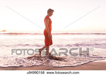 Mature woman strolling in sea at sunset, Nosara, Guanacaste Province, Costa Rica View Large Photo Image Stock Photo - Mature woman strolling in sea at sunset, Nosara, Guanacaste Province, Costa Rica. Fotosearch