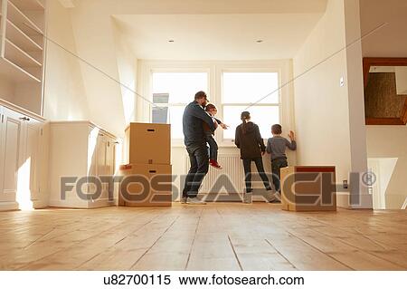 Mid adult man and three children looking from window of new home View Large Photo Image Stock Photography - Mid adult man and three children looking from window of new home. Fotosearch